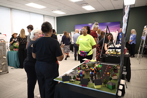 A room of the finalists showing their work to guests at the ETS Minnesota Business Accelerator finale