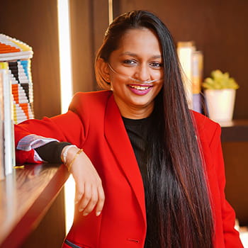 headshot of Shavini Fernando next to a bookcase headshot of Shavini Fernando next to a bookcase