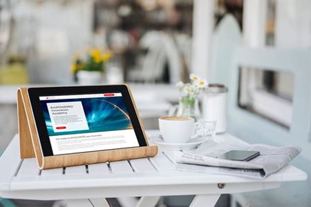 a digital tablet, newspaper, smartphone and coffee cup are sitting on a white table inside a bright living space a digital tablet, newspaper, smartphone and coffee cup are sitting on a white table inside a bright living space