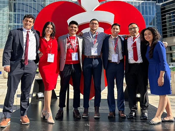 A group of NHLCC scholars standing in front of the AHA's life-size heart and torch sculpture. A group of NHLCC scholars standing in front of the AHA's life-size heart and torch sculpture.